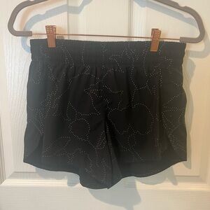 Athleta women’s mid rise racer run short. Built in liner. Black with pattern.